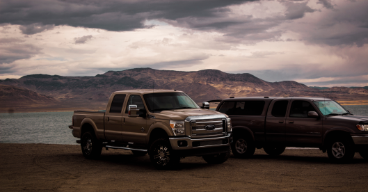 Medium-duty trucks in front of mountains